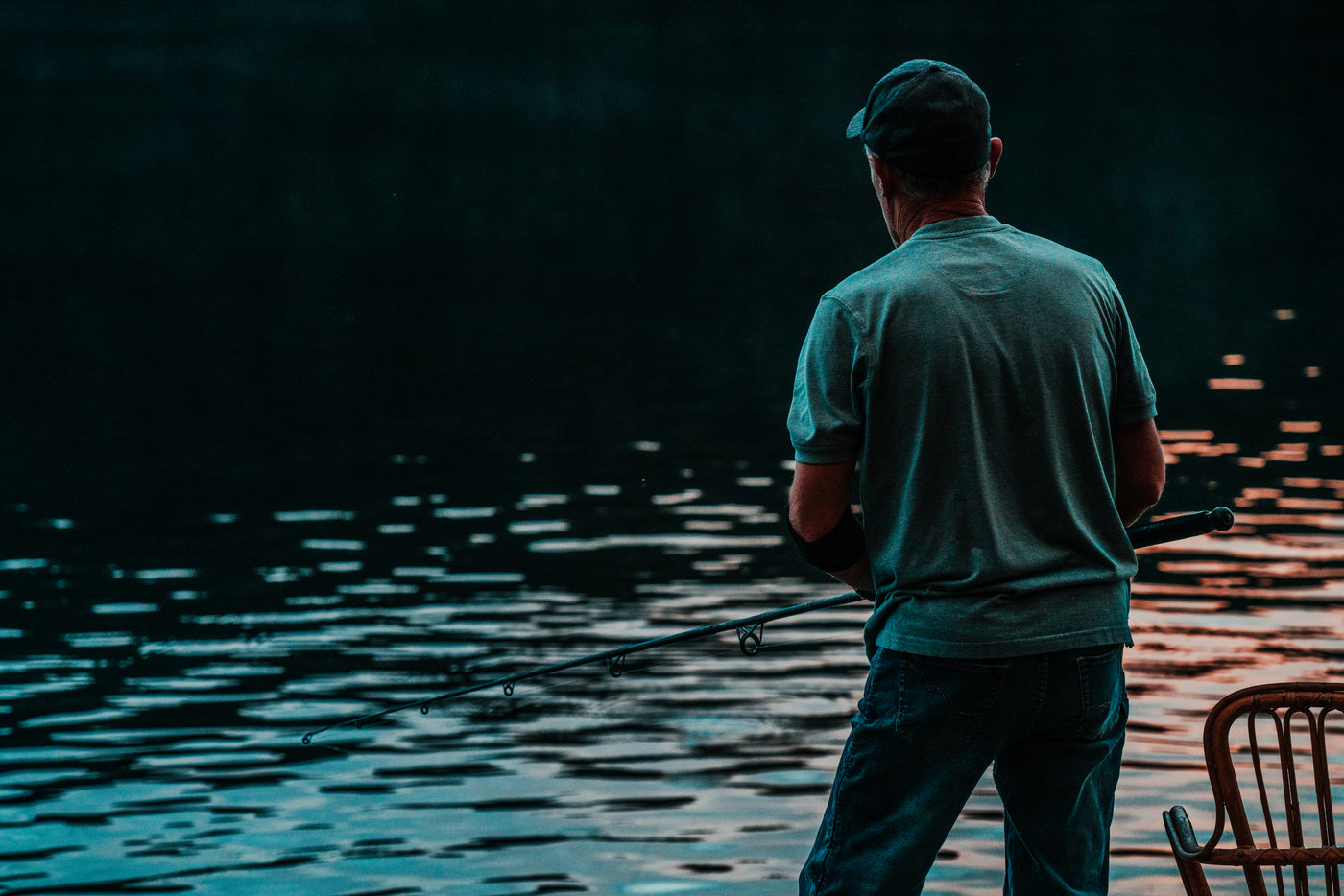 night angler at the rods — full setup lit up